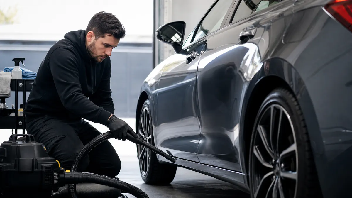 Auto detailing technician working on a vehicle